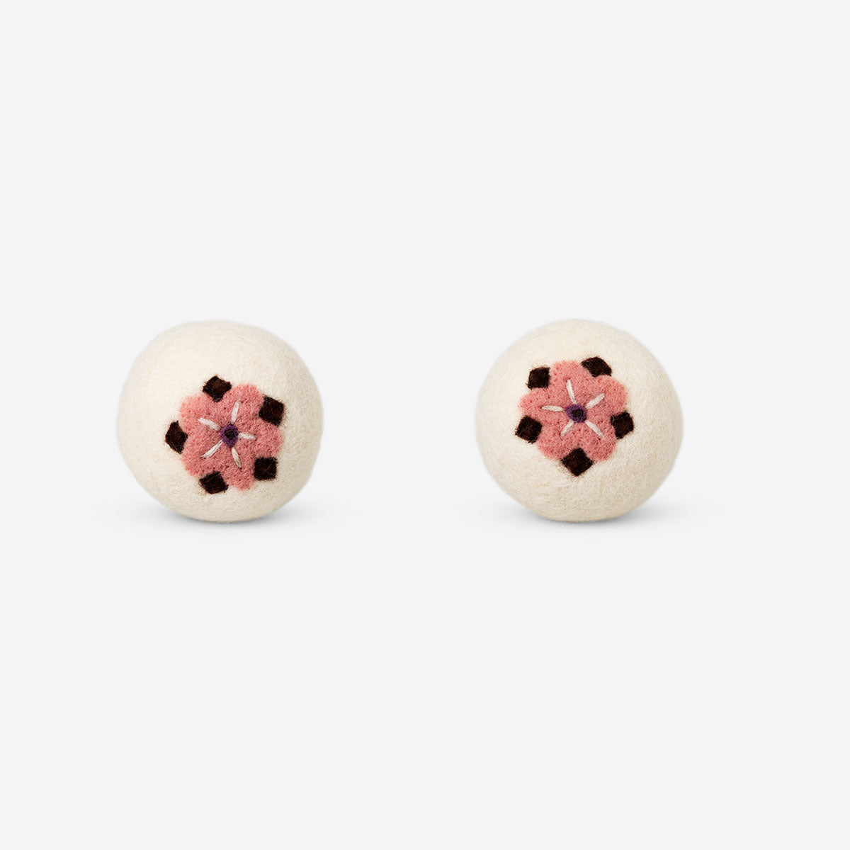 Two Flying Tiger Copenhagen wool laundry balls with colorful flower motifs for eco-friendly washing.