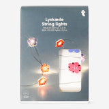 Flying Tiger Copenhagen purple and pink flower string lights, decorative home lighting with floral design.