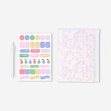Flying Tiger Copenhagen floral office notebook with matching ballpoint pen and decorative stickers on a white background.
