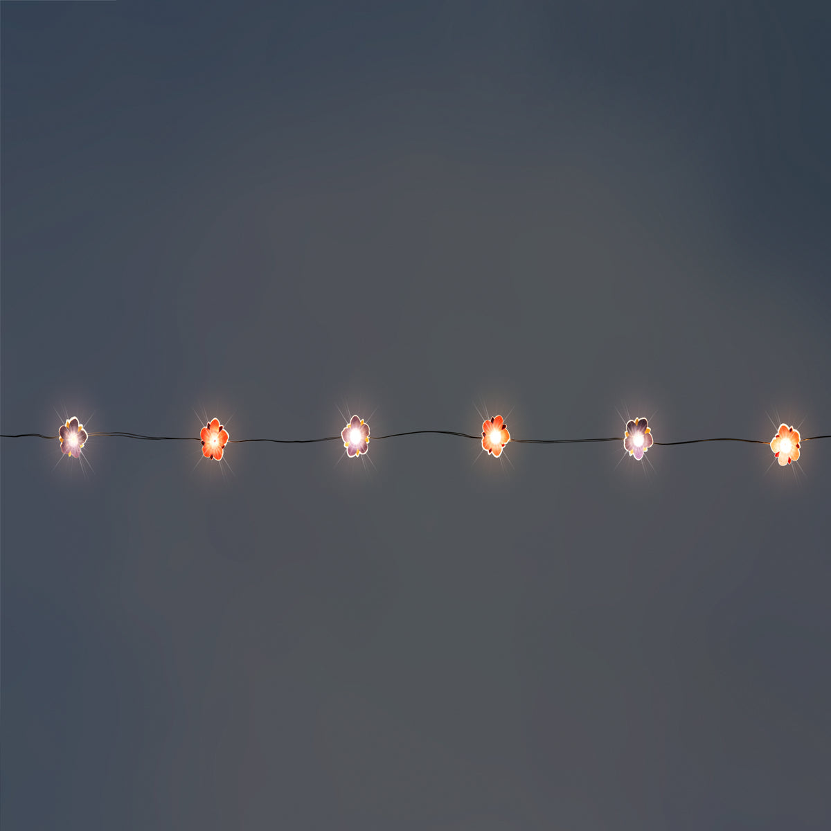 Flying Tiger Copenhagen purple and pink flower string lights for home decor, featuring illuminated floral designs.