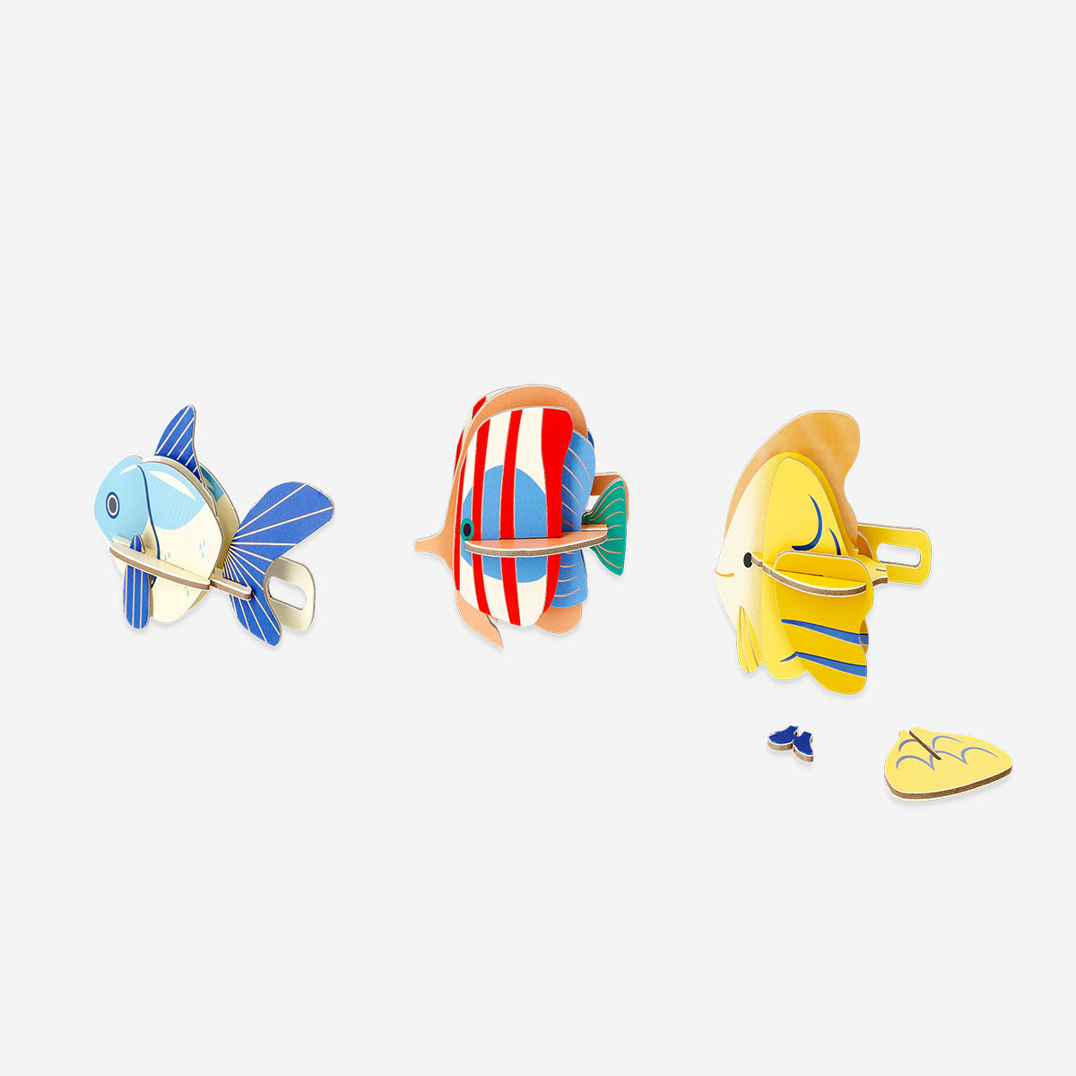 Three DIY cardboard fish craft kits by Flying Tiger Copenhagen, featuring colorful and textured fish for hobby and creative projects.