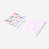 Floral Flying Tiger Copenhagen office notebook with matching ballpoint pen and colorful stickers on a desk.