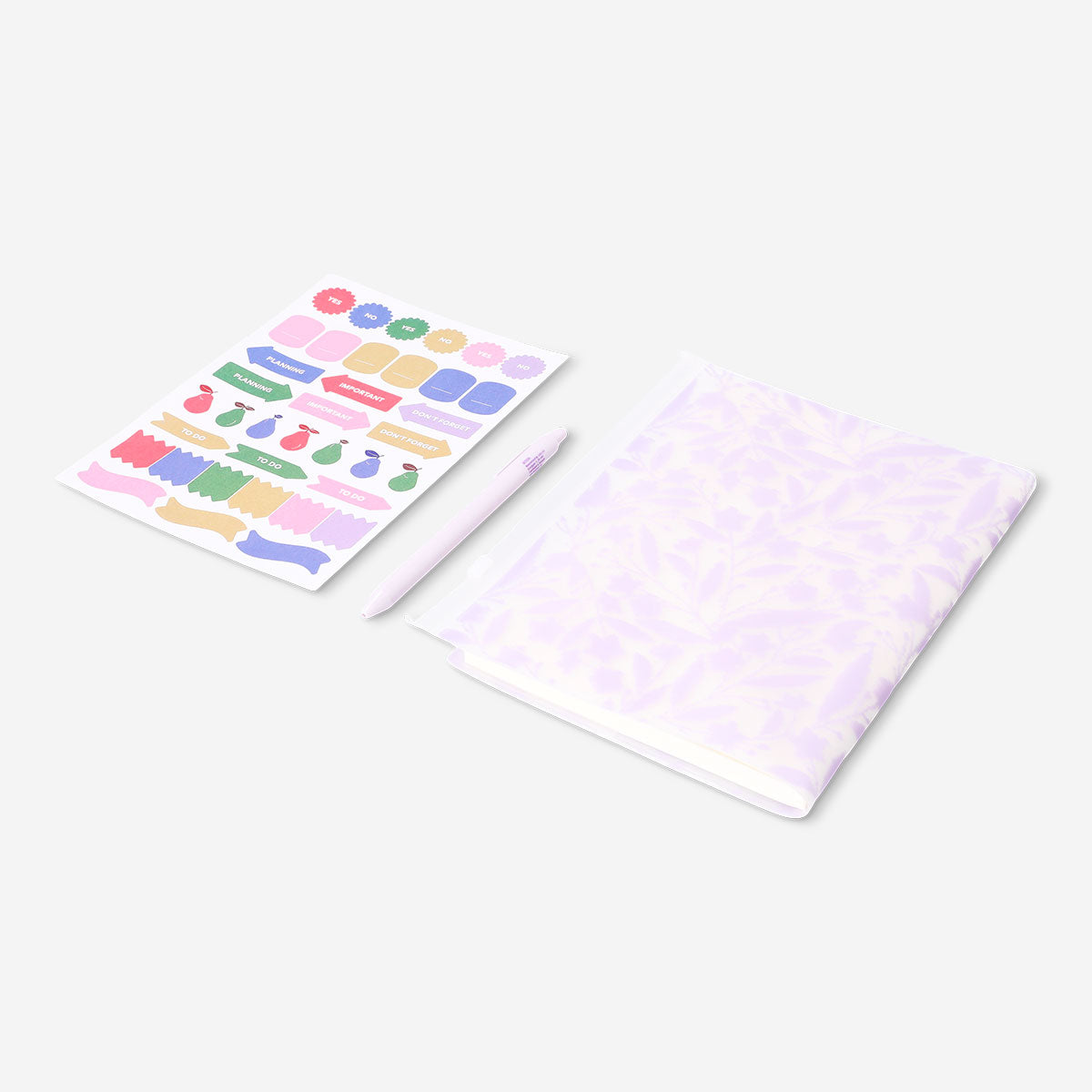 Floral Flying Tiger Copenhagen office notebook with matching ballpoint pen and colorful stickers on a desk.