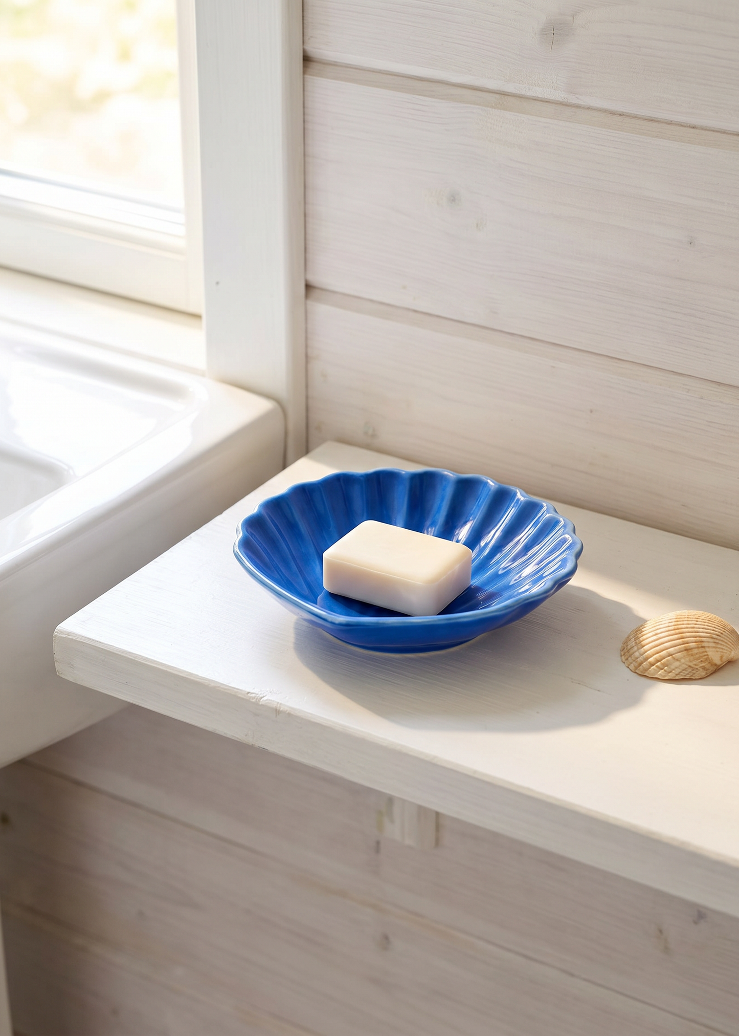 Blue ceramic seashell soap dish for home use, featuring a detailed seashell design from Flying Tiger Copenhagen.