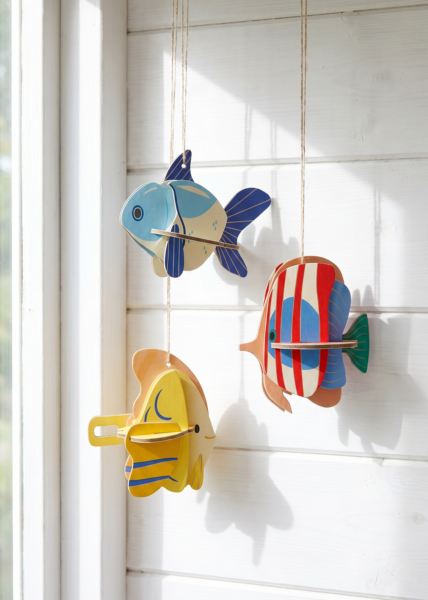 Three DIY cardboard fish craft kits from Flying Tiger Copenhagen, perfect for hobby projects and creative activities.