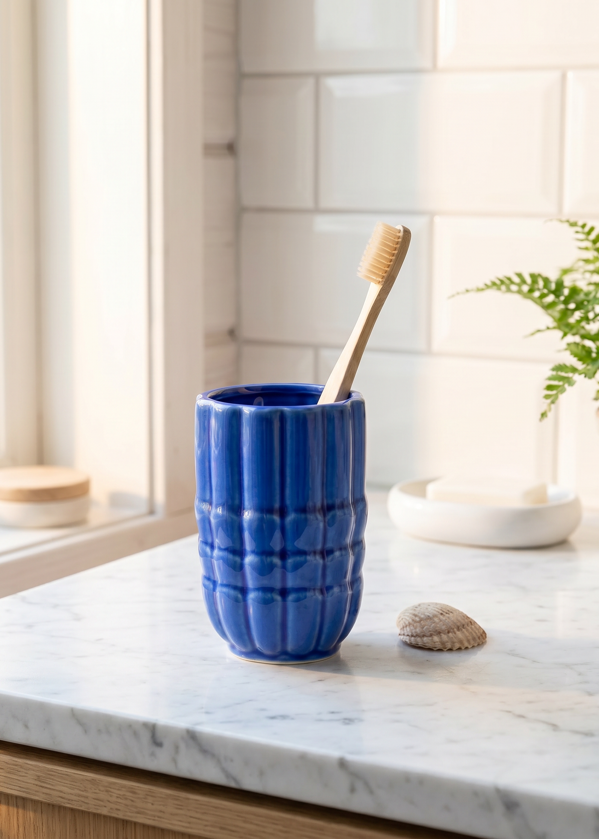 Blue ceramic seashell toothbrush holder from Flying Tiger Copenhagen, featuring a seashell design for home bathroom decor.