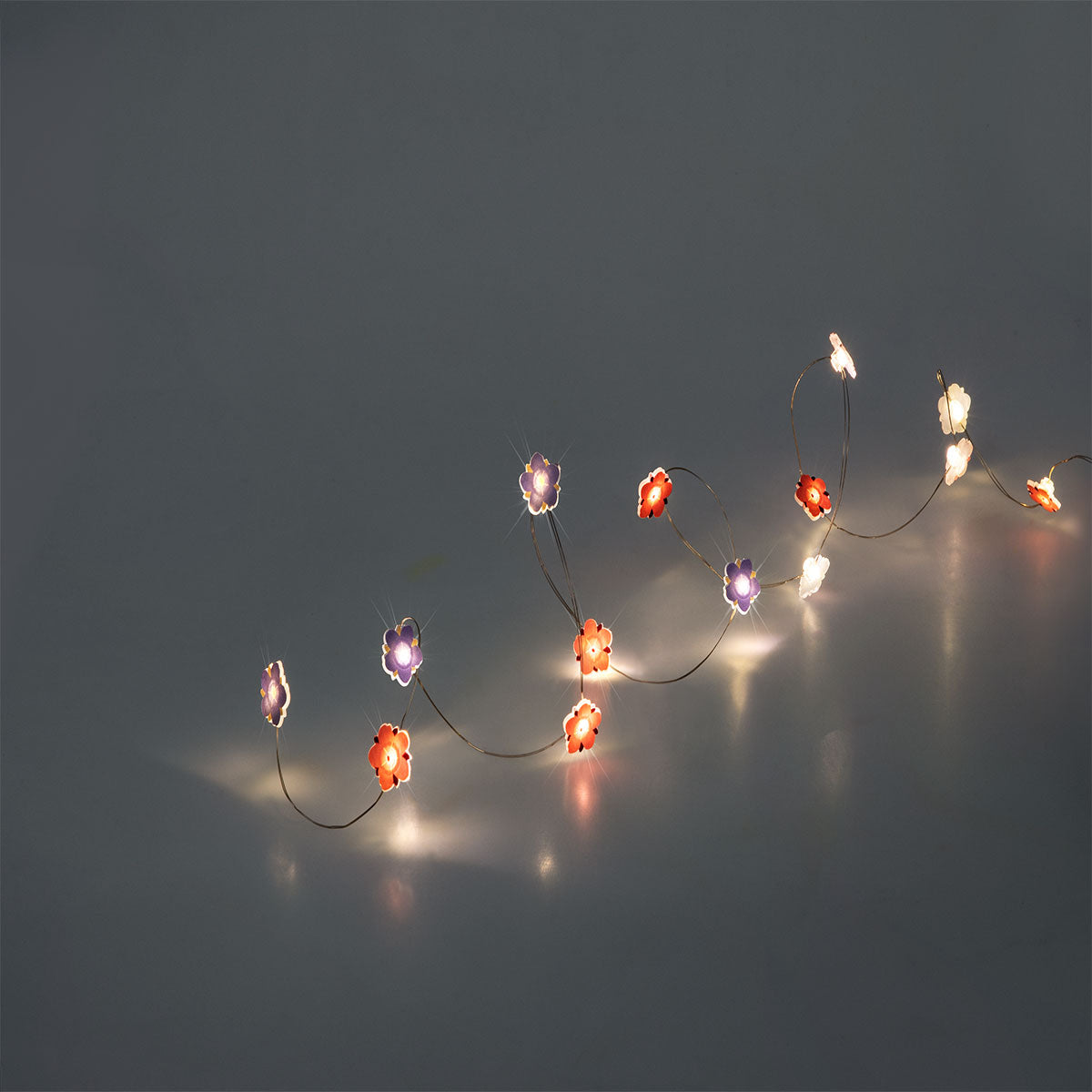Flying Tiger Copenhagen string lights with purple and pink flower designs, perfect for home decor.