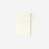 Beige notebook with ballpoint pen