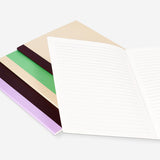 Set of four Flying Tiger Copenhagen A5 notebooks with colorful covers, ideal for office or school note-taking.